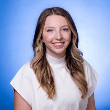 Headshot of Teagan Thomas on a blue background