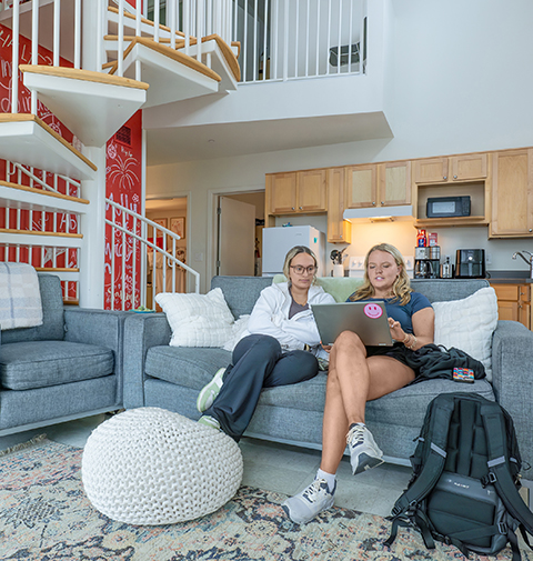 Two students hanging out in the Legacy Park apartment.