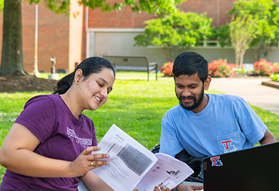 International student studying in the Quad.