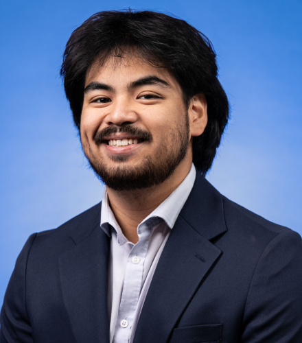 Headshot of Andrew Black on a blue background