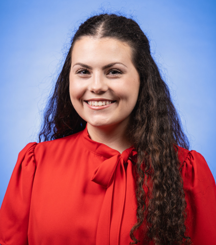 Headshot of Gracie Vidrine on a blue background