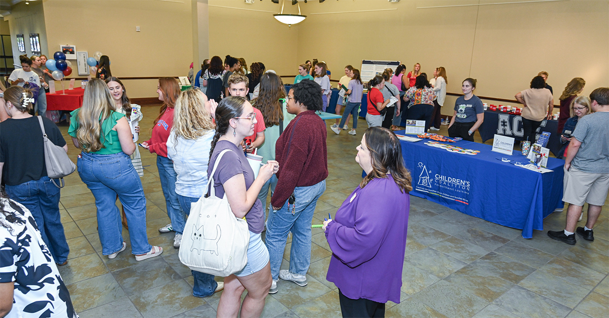 People gather at different booths in the Lincoln Parish Library event space