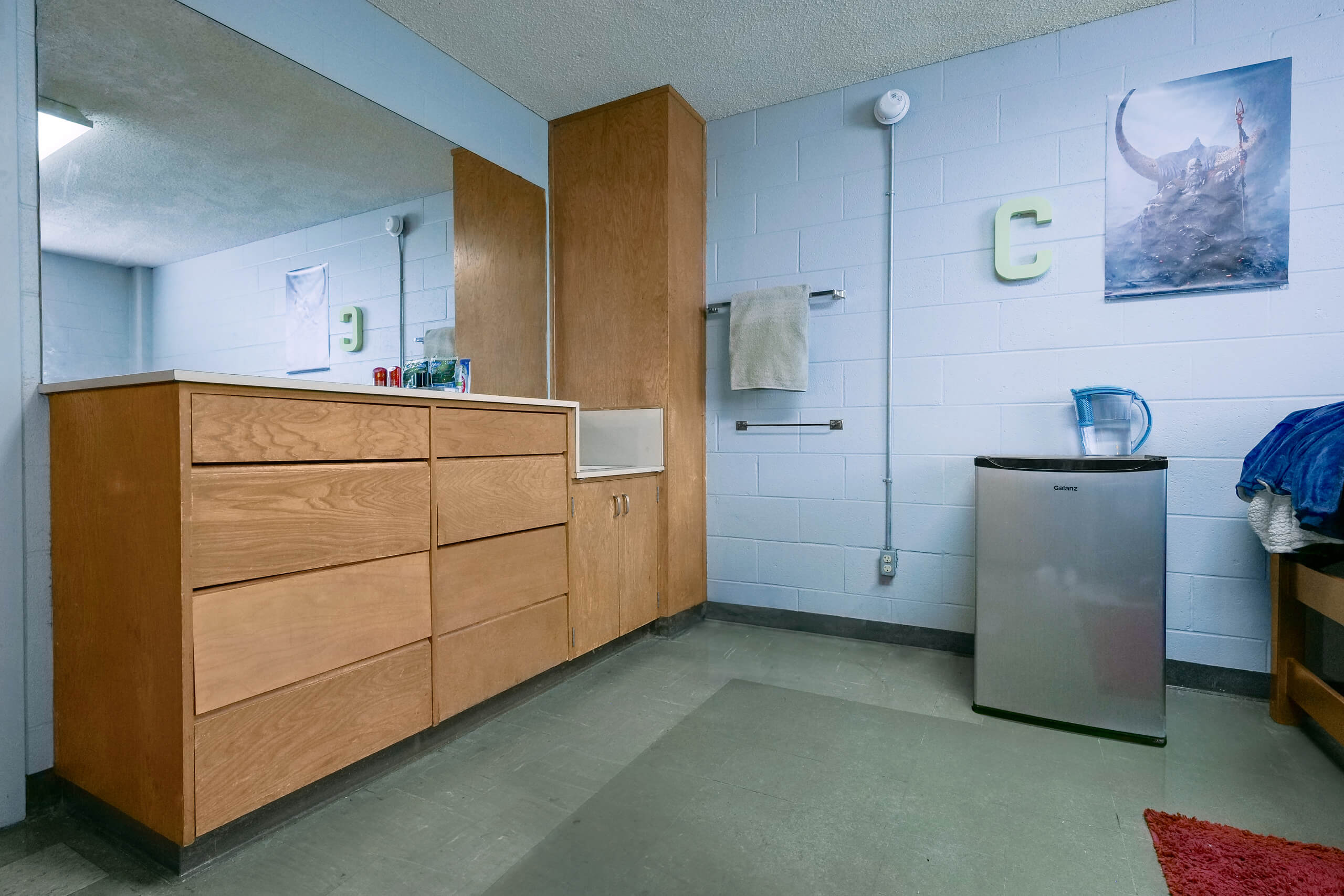 A dresser and closet inside of a Graham Hall dorm room.