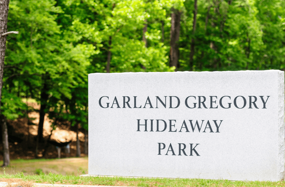 A concrete sign outdoors reads "Gregory Garland Hideaway Park"