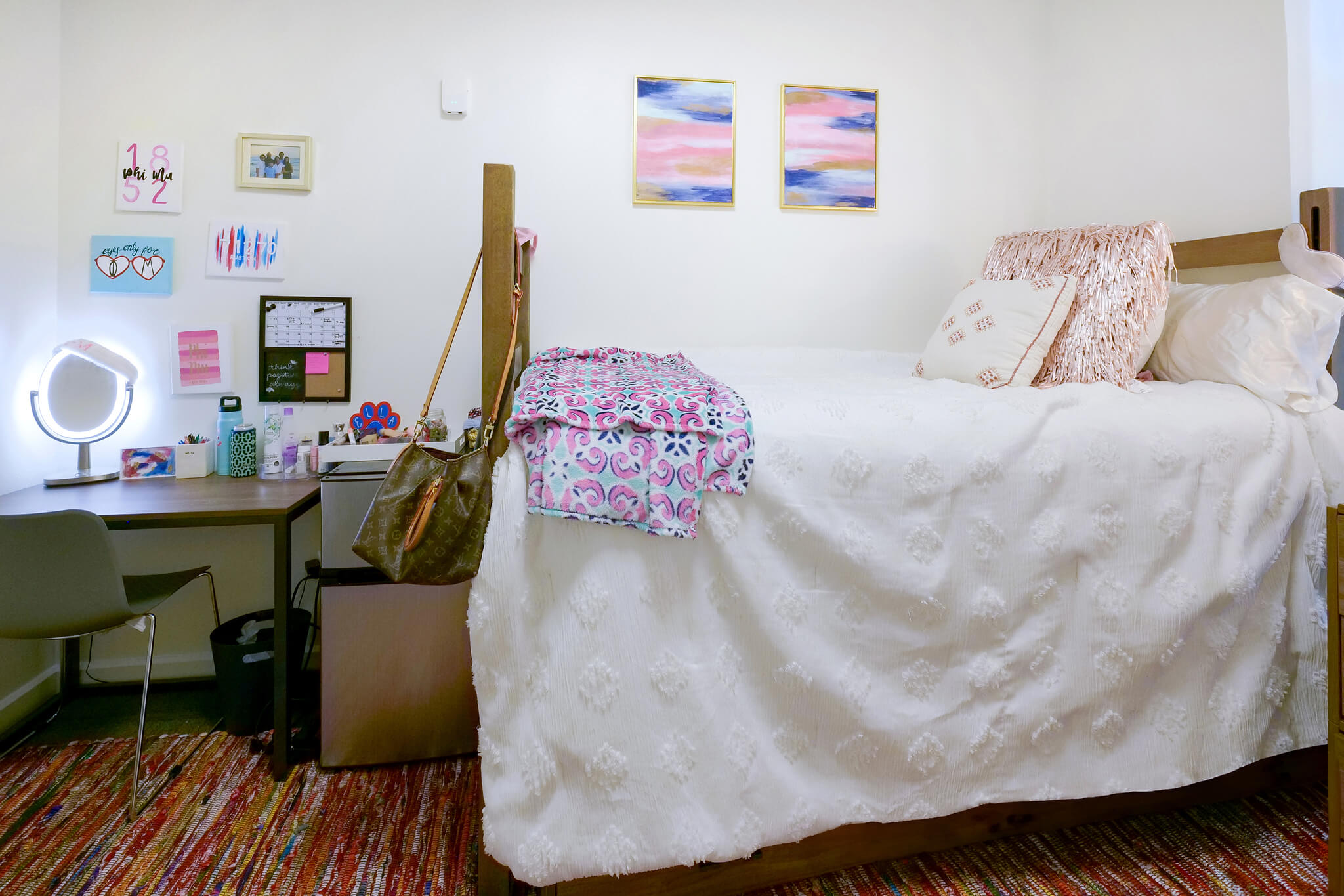A well-made bed and desk in Richardson Hall