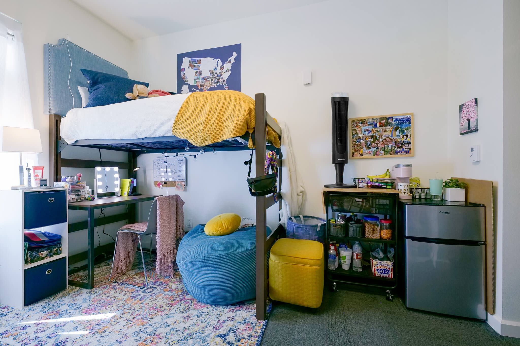A bed, desk, and living space in a Richardson Hall room