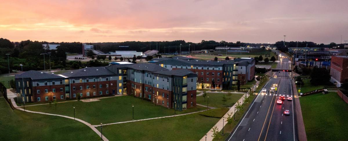 Tech Drive and Louisiana Tech residential halls at sunset.