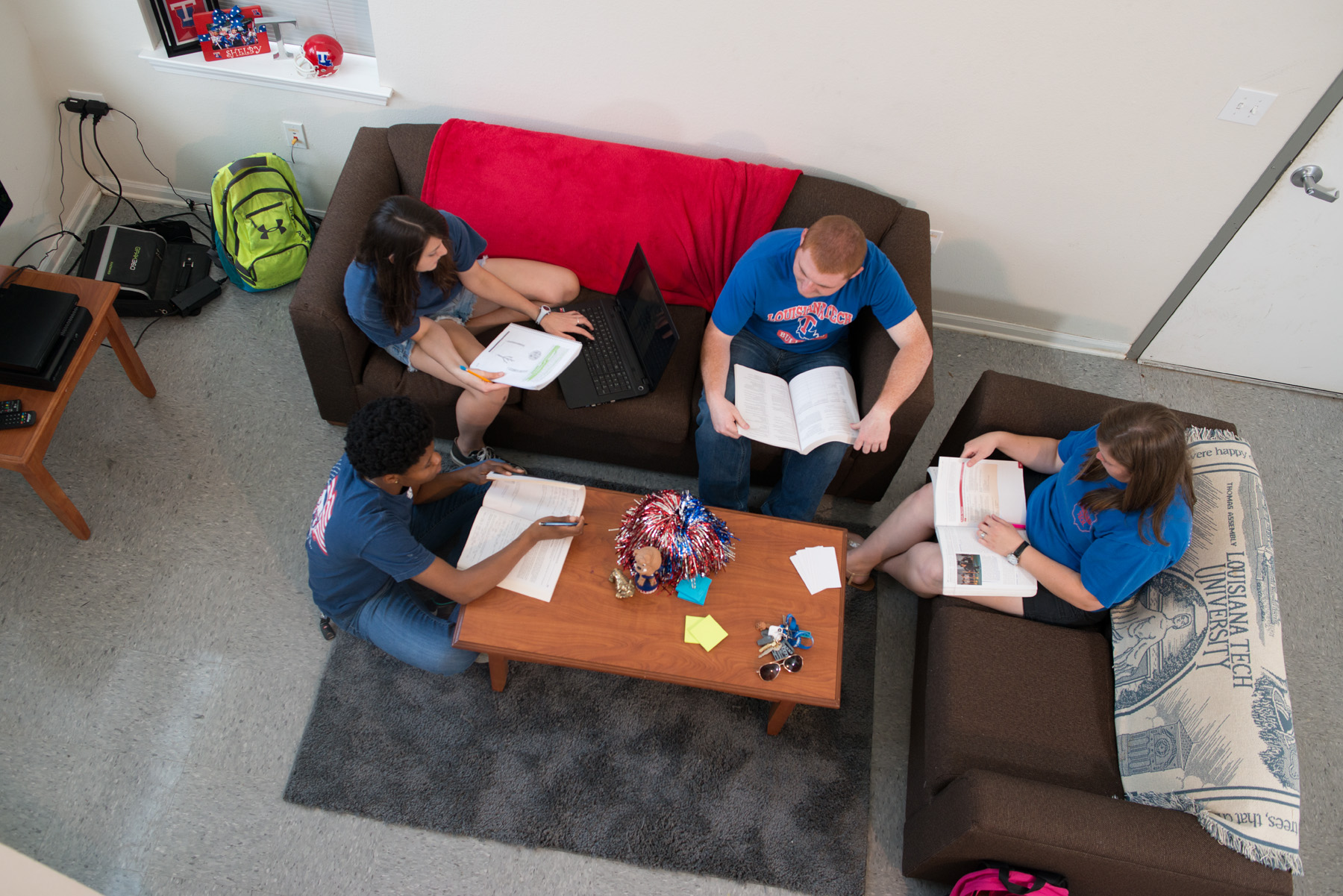 Students sit and chat in the living room area of a University Park unit
