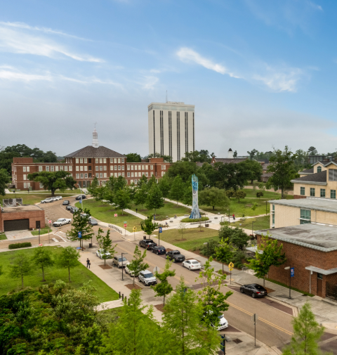 Aerial of campus that includes Keeny Hall, Wyly Tower, and the College of Business