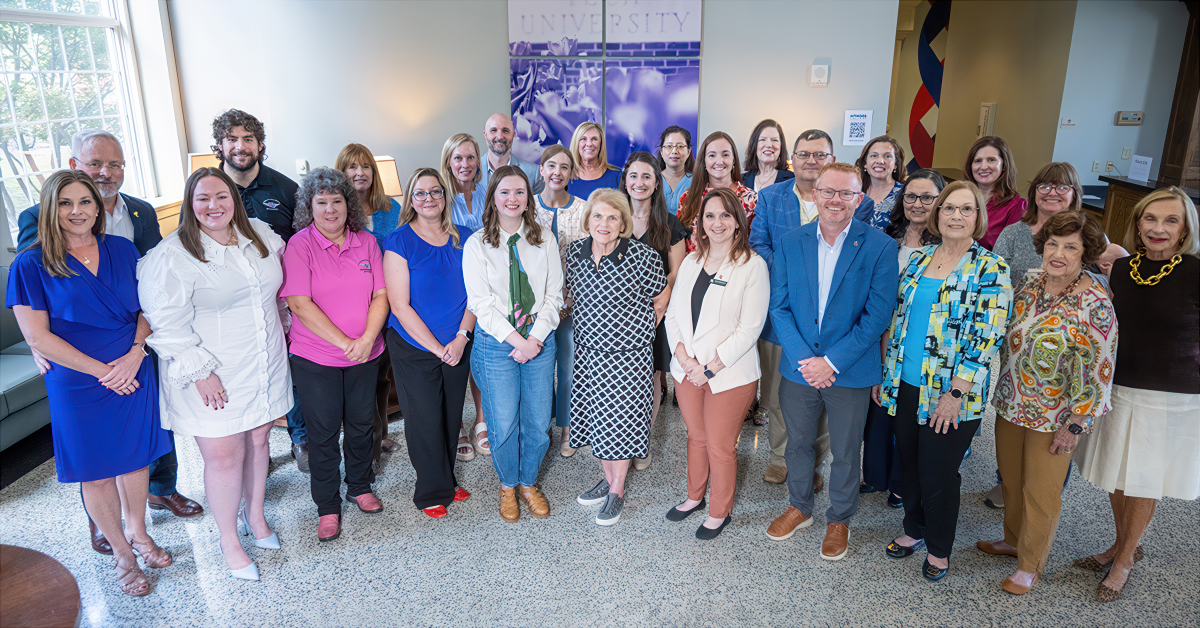 A group poses during the Lagniappe Ladies reception in University Hall