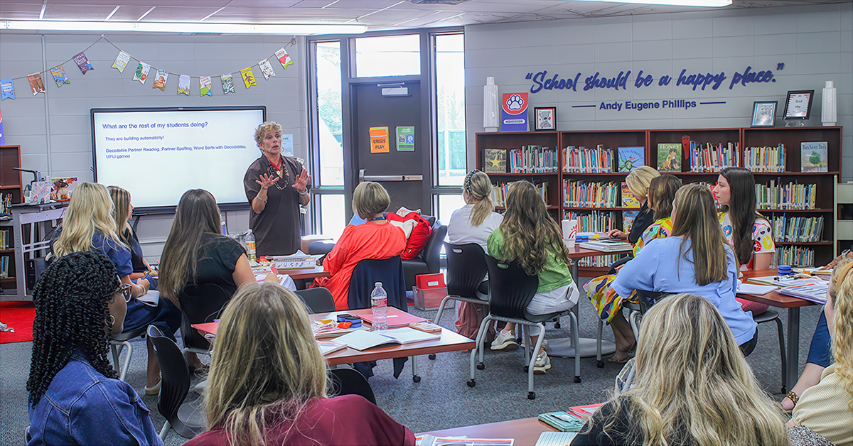 A woman teaches in a classroom