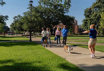 A family is treated to a tour by a student recruiter and Tech XXII.