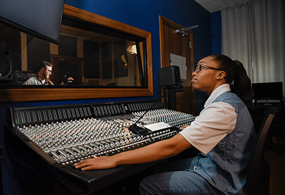 Music students work in the recording studio.