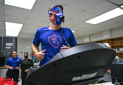A person runs on a treadmill while tracking VO2 max.