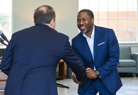 Banker graduating from the School of Banking and shaking hands