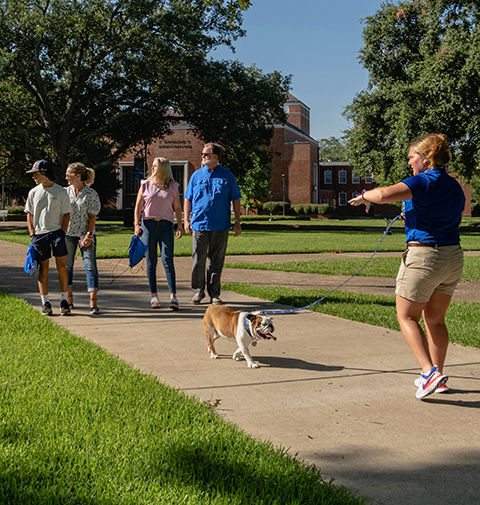 A student recruiter and Tech XXII give a tour to a prospective student.
