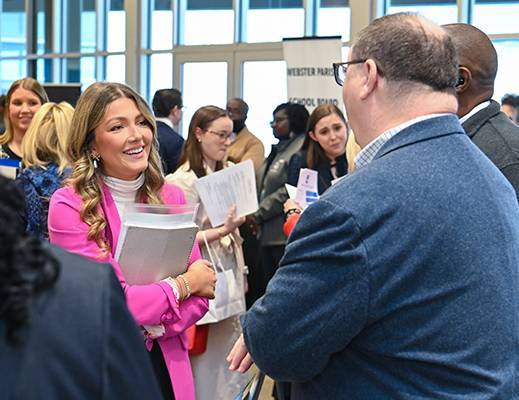 A student speaks to prospective employers at a career fair