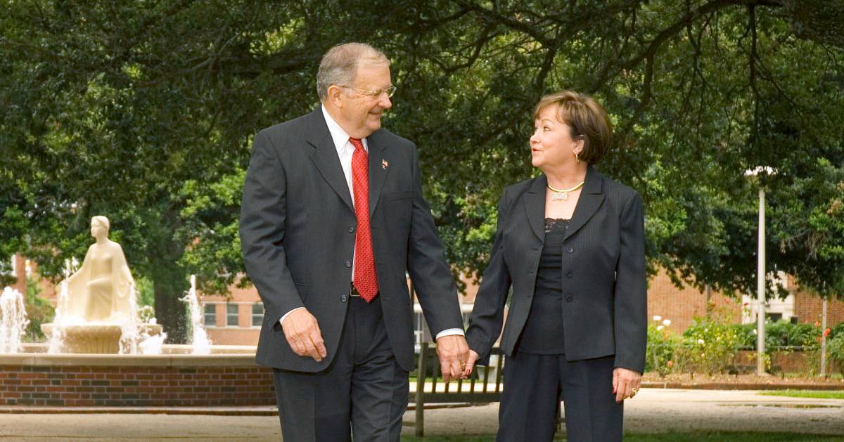 Dr. Dan Reneau and Mrs. Linda Reneau walk hand-in-hand through the Quad on Louisiana Tech's campus.