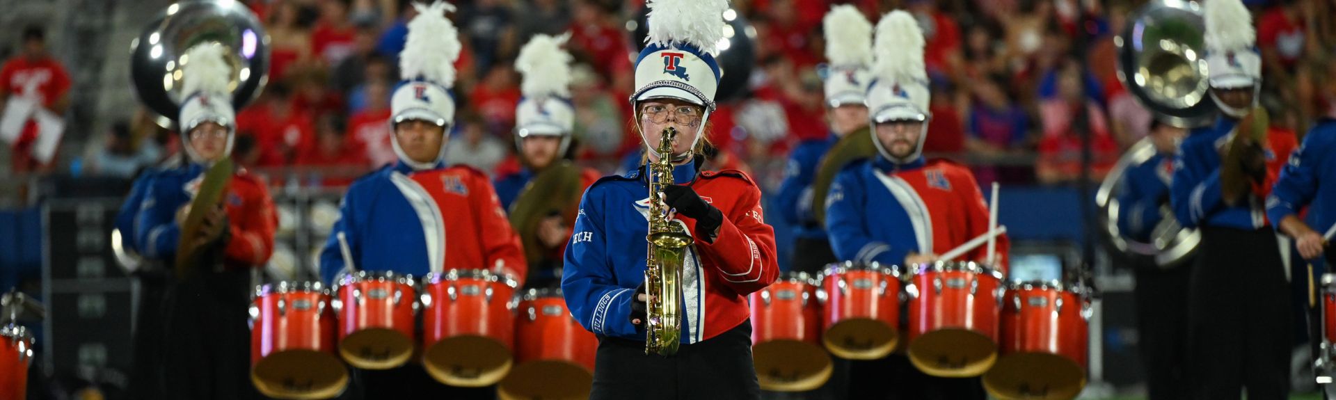students playing musical instruments on the football field 