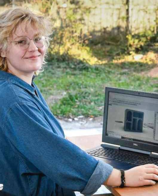 girl working on laptop in workshop