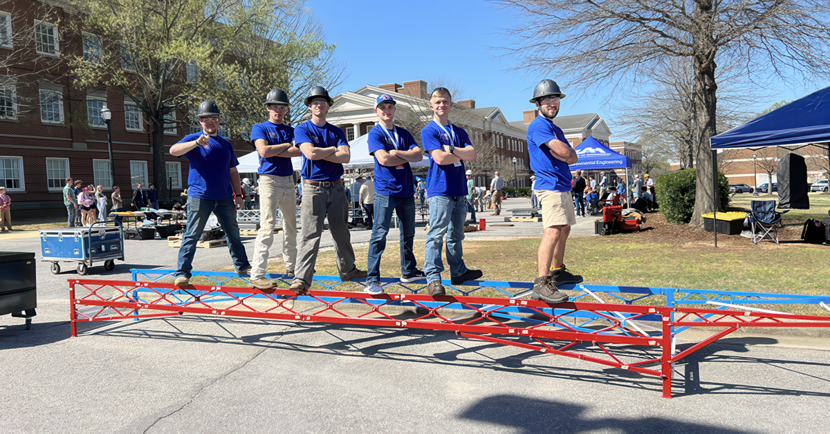 A team of Louisiana Tech student engineers stand on their steel bridge