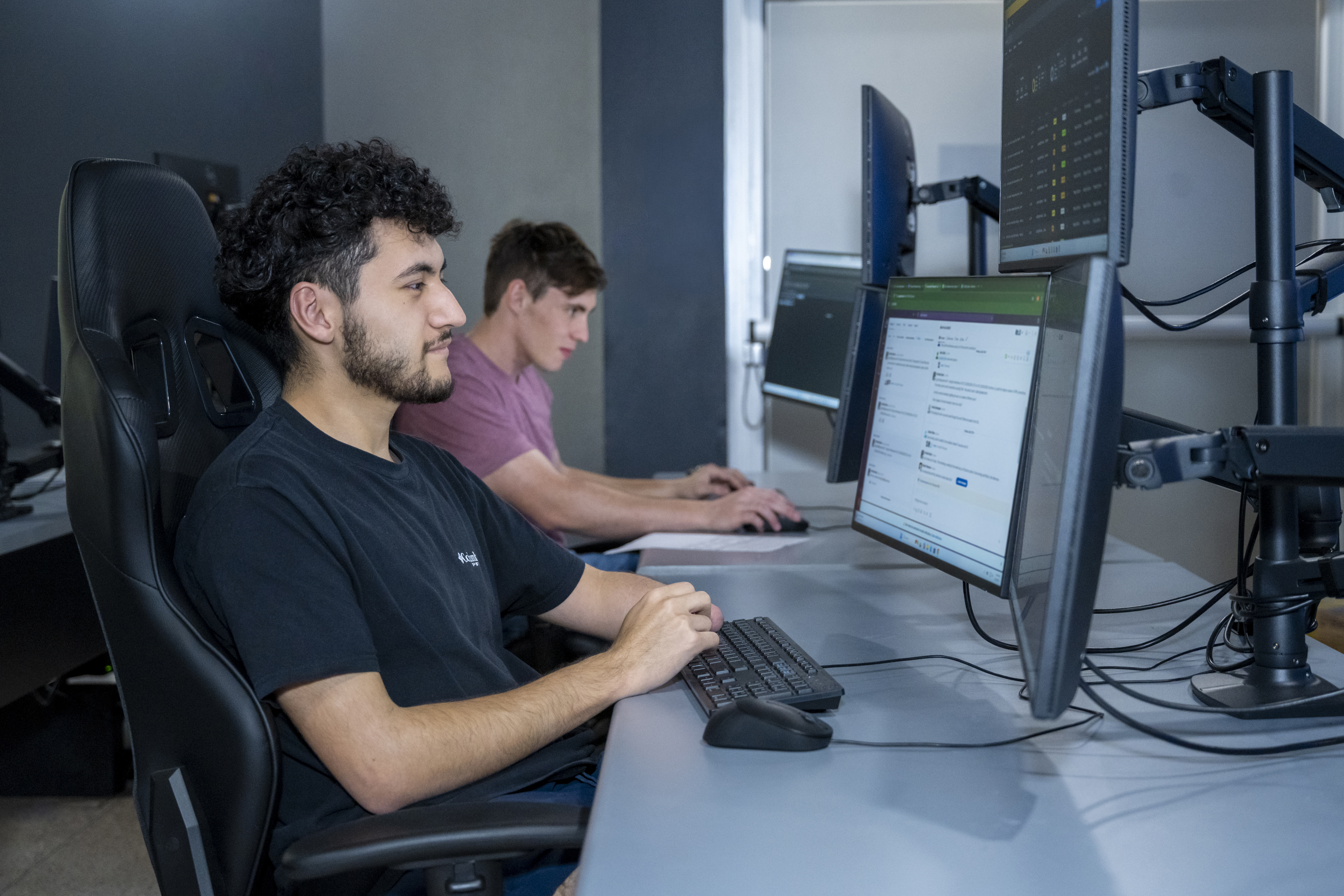Students sitting on a chair looking at his desktop screen